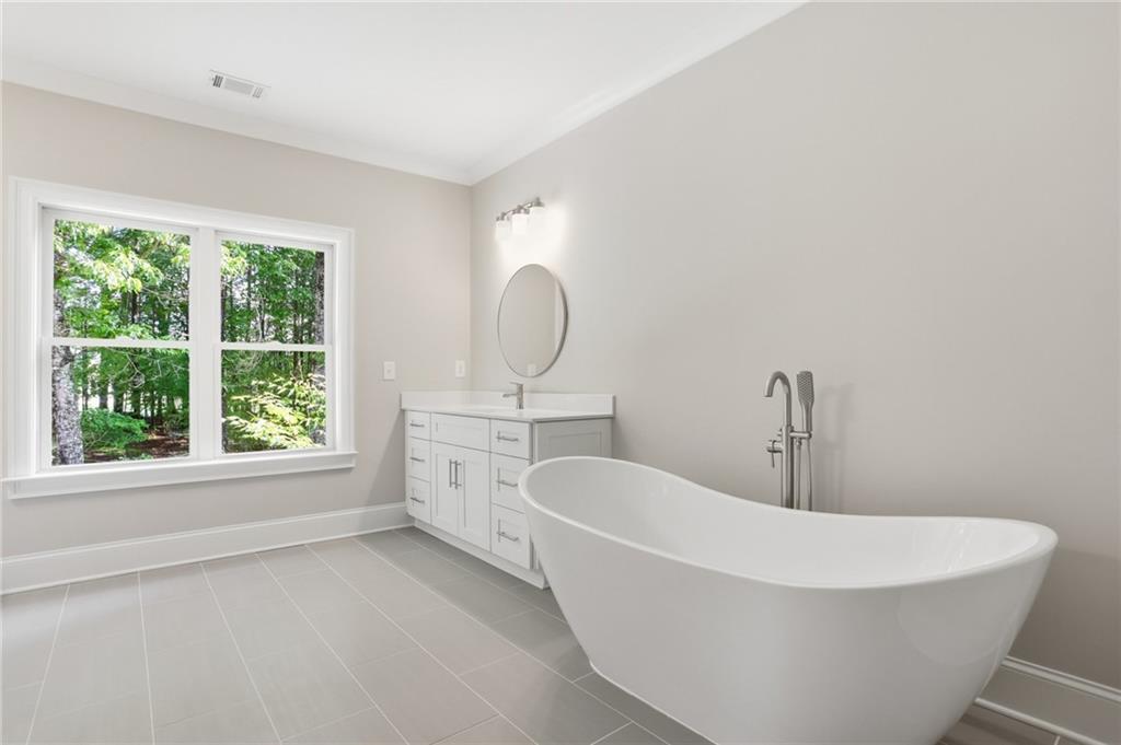 222 Trecastle Square, Unit 21 Canton, GA 30114 - Photo 29 of 33 a white bath tub sitting in a bathroom next to a window