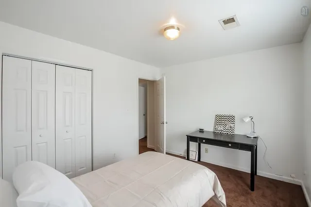 a bedroom with a bed and a table