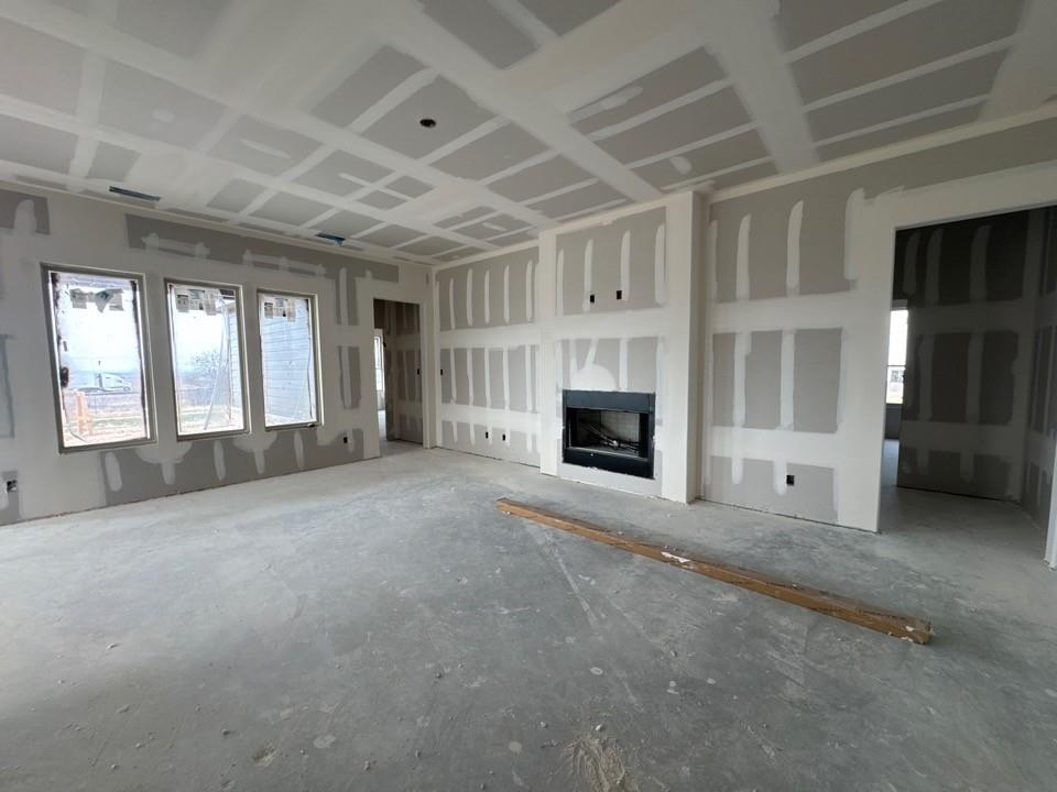 197 Brandywine Trail Rhome, TX 76078 - Photo 4 of 14 a view of an empty room with a fireplace and a window