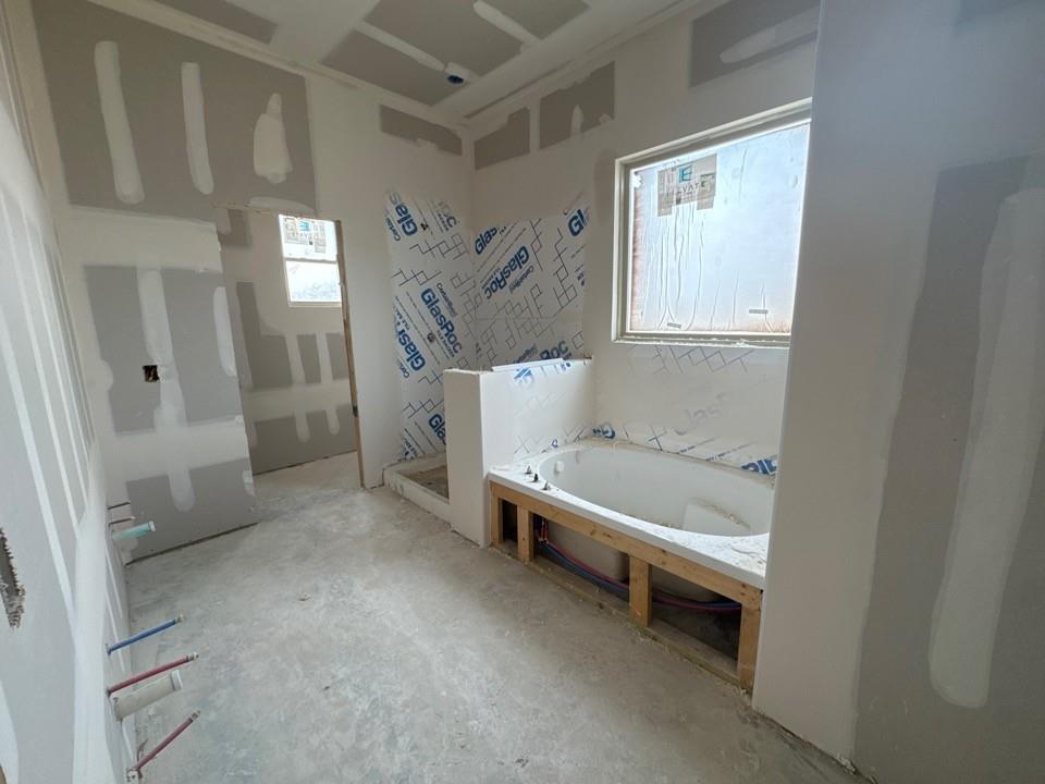 197 Brandywine Trail Rhome, TX 76078 - Photo 8 of 14 a bathroom with a tub and a window