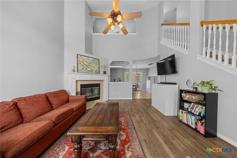 a living room with furniture fireplace and flat screen tv