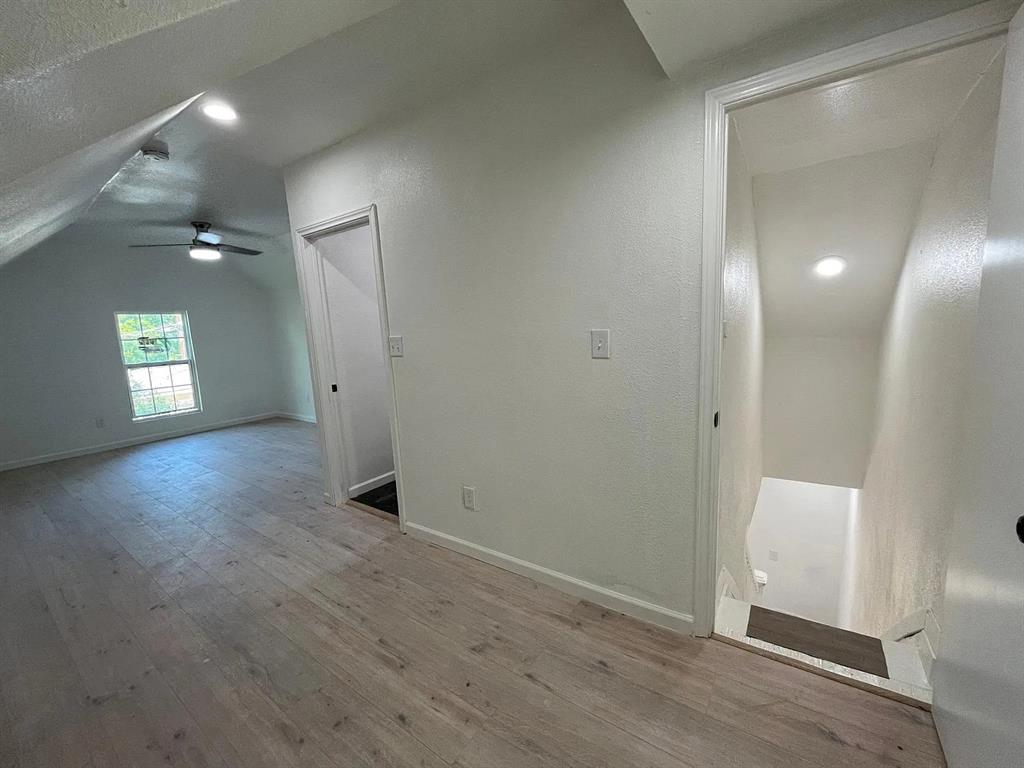 2851 Casey Street Dallas, TX 75215 - Photo 15 of 22 an empty room with wooden floor and mirror