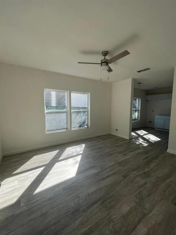 2851 Casey Street Dallas, TX 75215 - Photo 20 of 22 an empty room with wooden floor and windows