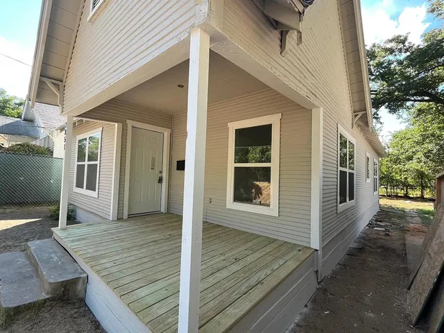 a view of a house with a wooden deck