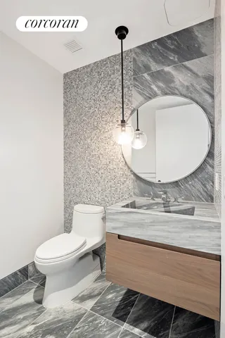 a bathroom with a tub sink and mirror