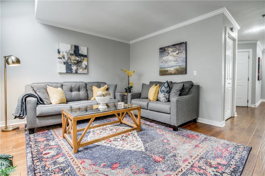 a living room with furniture and wooden floor