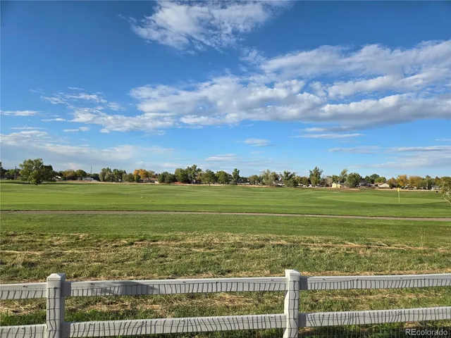 a view of a balcony with furniture and a garden