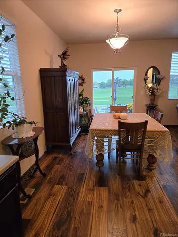 a view of a dining room with furniture window and wooden floor