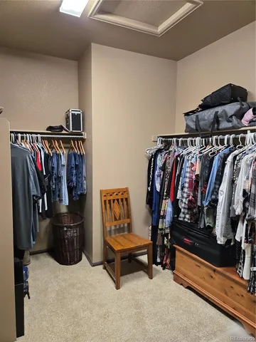 a view of walk in closet with clothes