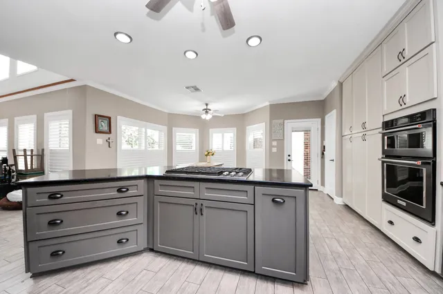 a kitchen with stainless steel appliances granite countertop a stove and a sink