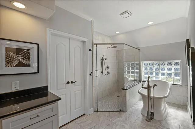 a spacious bathroom with a granite countertop sink toilet and shower