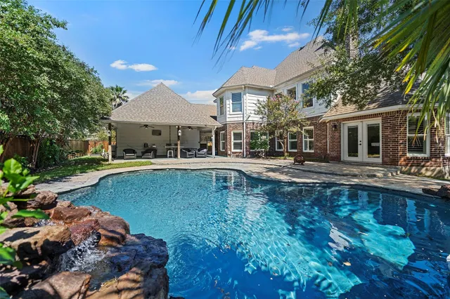 a swimming pool view with a outdoor seating