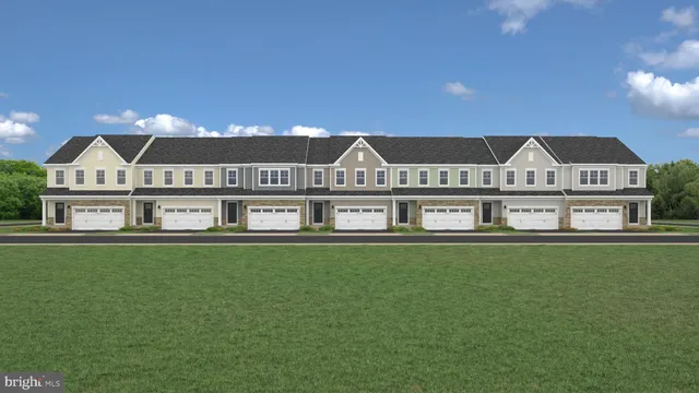 a view of a big house with a big yard and large trees