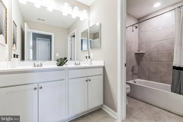 a white toilet sitting next to a bath tub