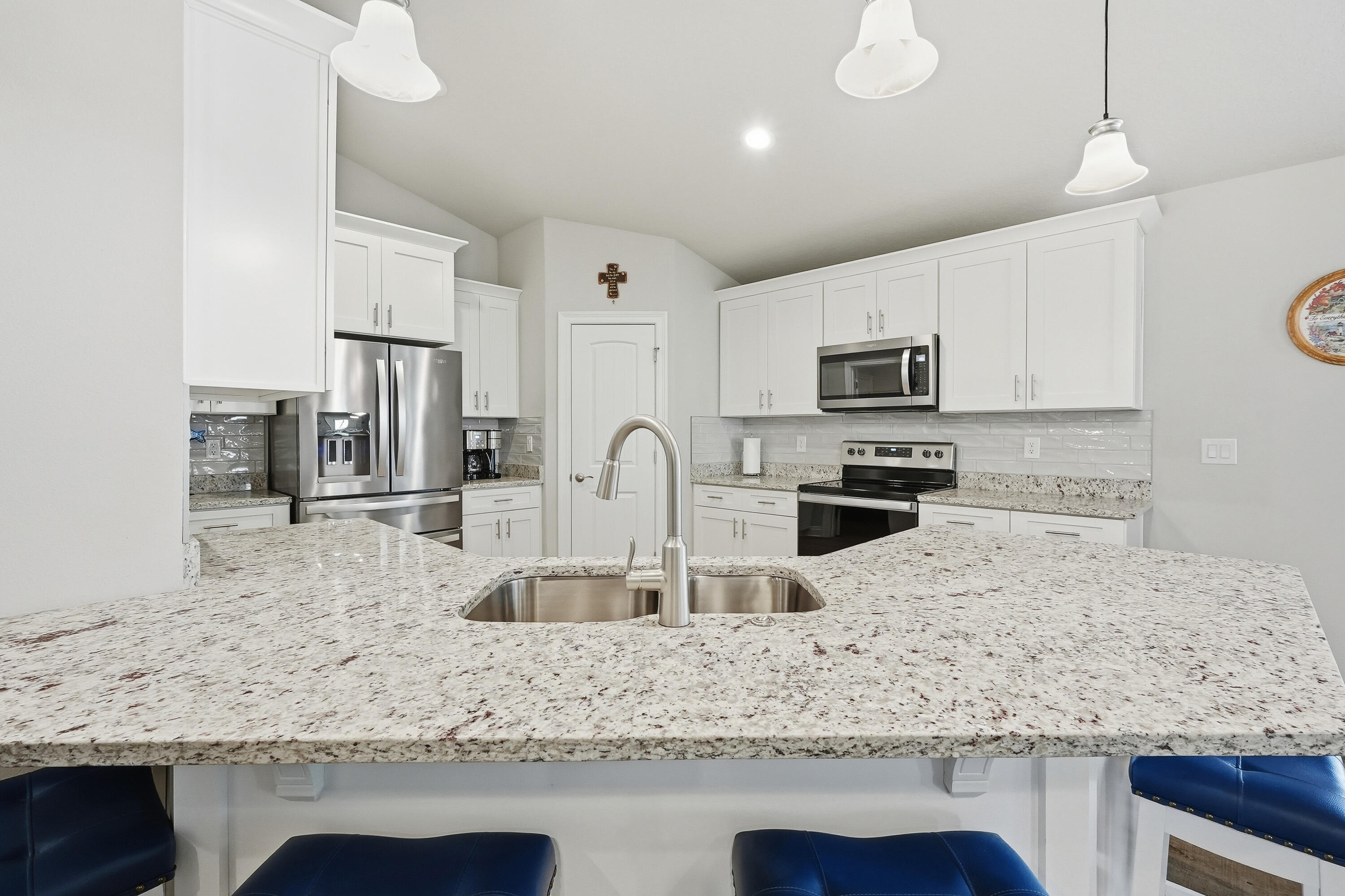7434 Gordon Evans Road Navarre, FL 32566 - Photo 13 of 51 a kitchen with stainless steel appliances granite countertop a sink stove and refrigerator