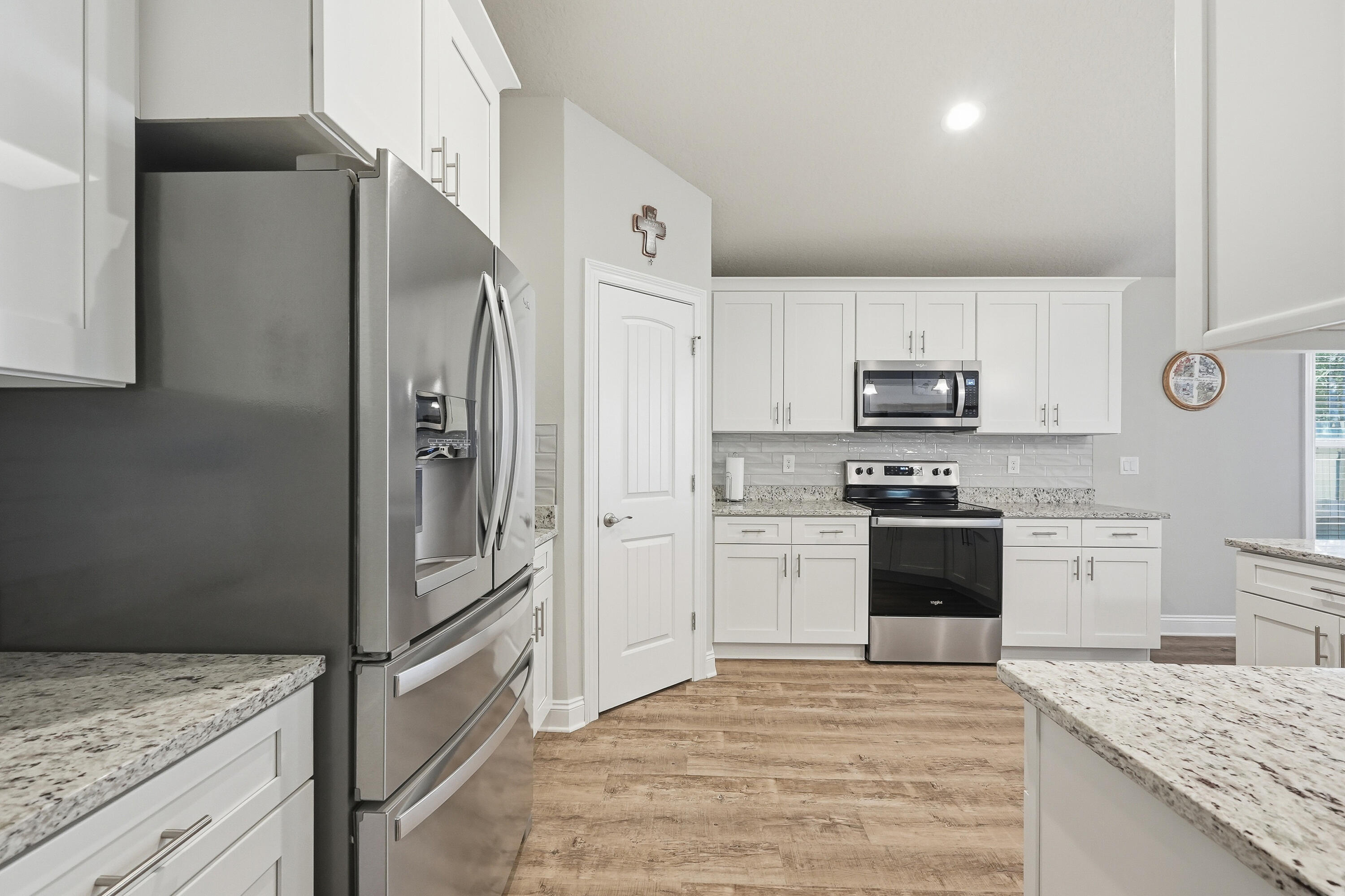 7434 Gordon Evans Road Navarre, FL 32566 - Photo 15 of 51 a kitchen with granite countertop a refrigerator stove and sink
