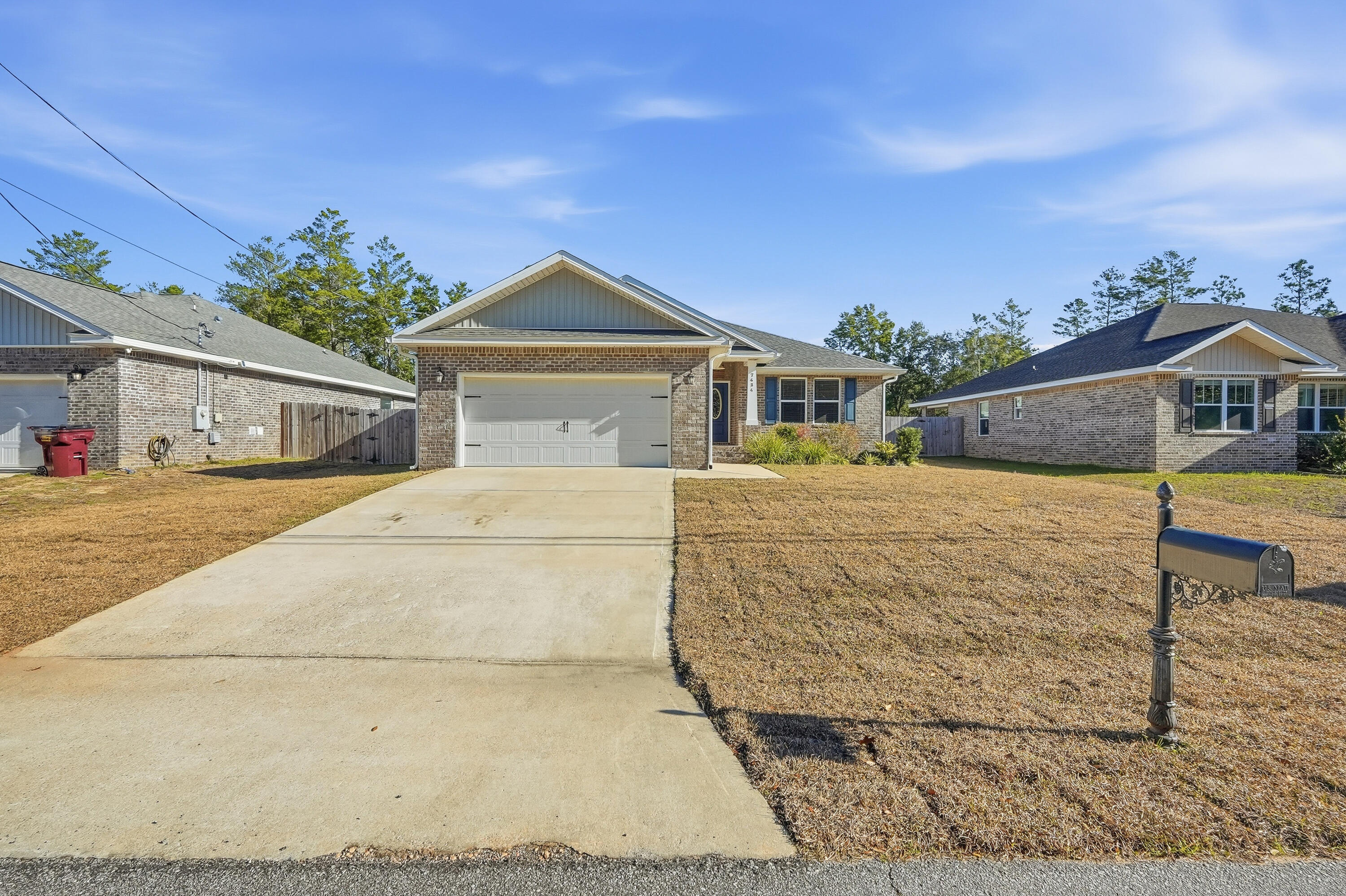 7434 Gordon Evans Road Navarre, FL 32566 - Photo 2 of 51 a front view of a house with a yard