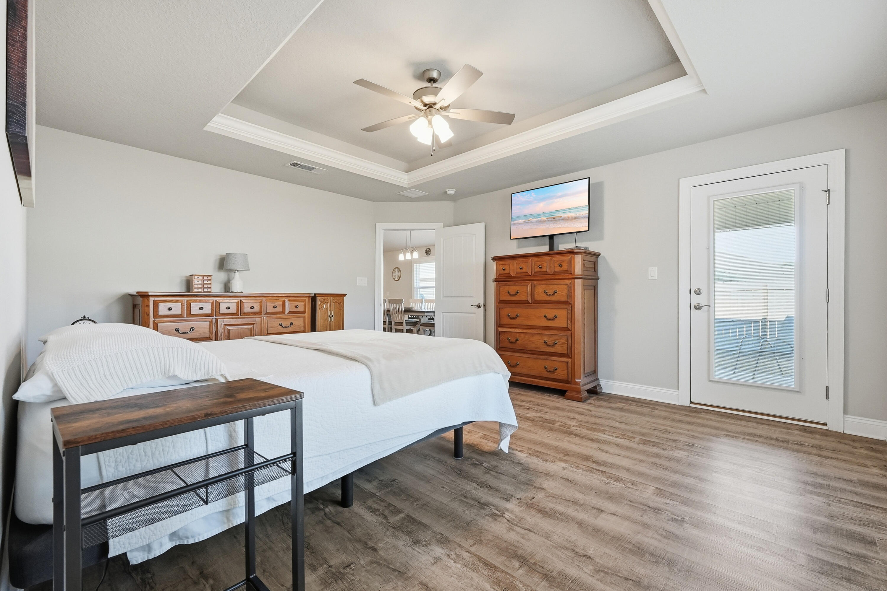 7434 Gordon Evans Road Navarre, FL 32566 - Photo 21 of 51 a bedroom with a bed a dresser and a chandelier