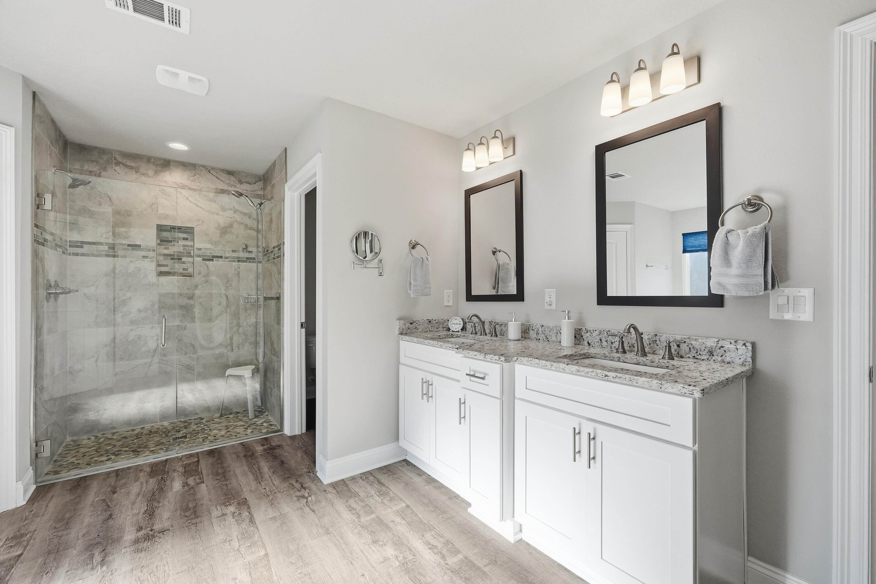 7434 Gordon Evans Road Navarre, FL 32566 - Photo 26 of 51 a bathroom with a double vanity sink mirror and shower