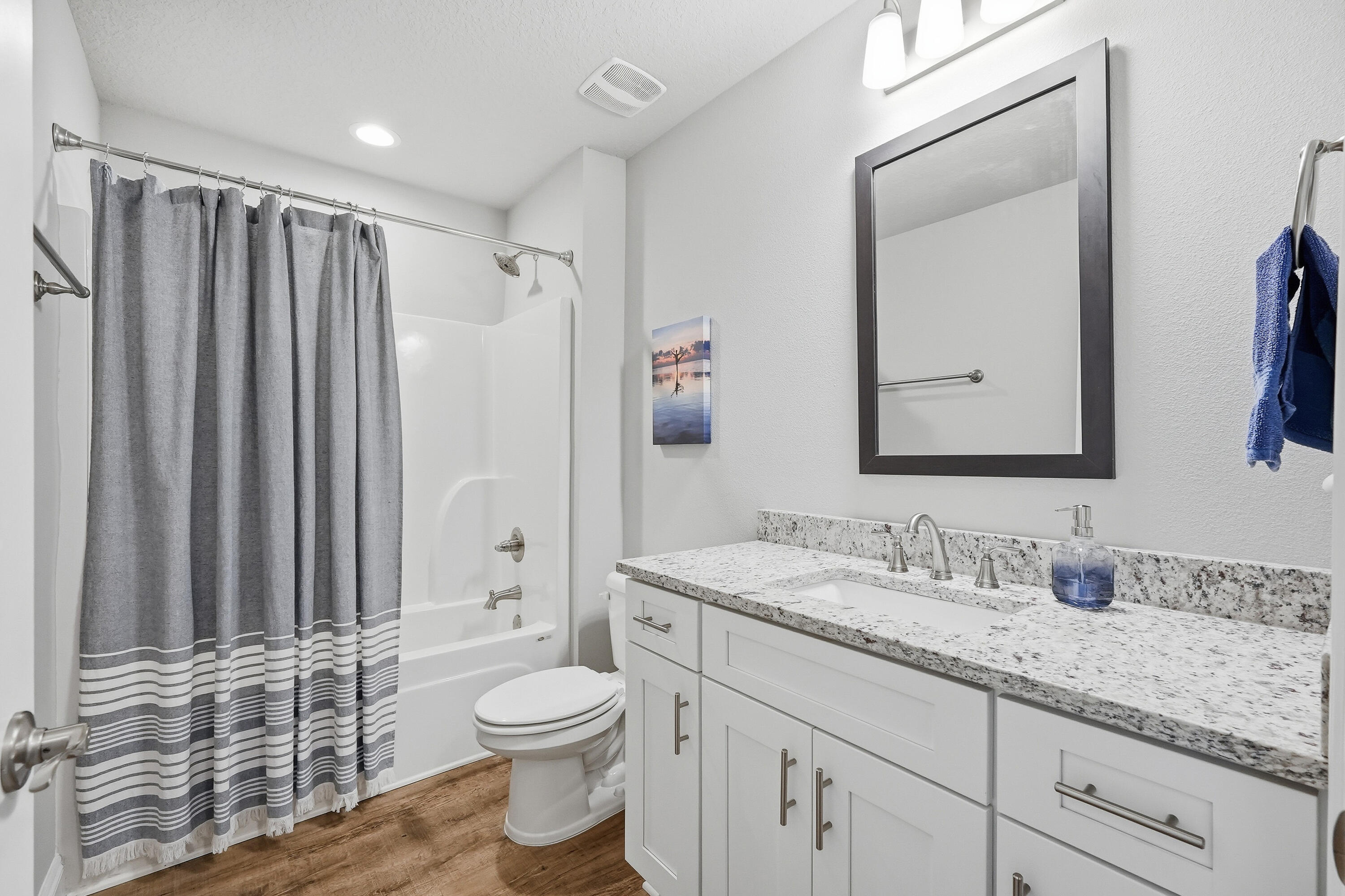 7434 Gordon Evans Road Navarre, FL 32566 - Photo 35 of 51 a bathroom with a granite countertop toilet a sink and a mirror