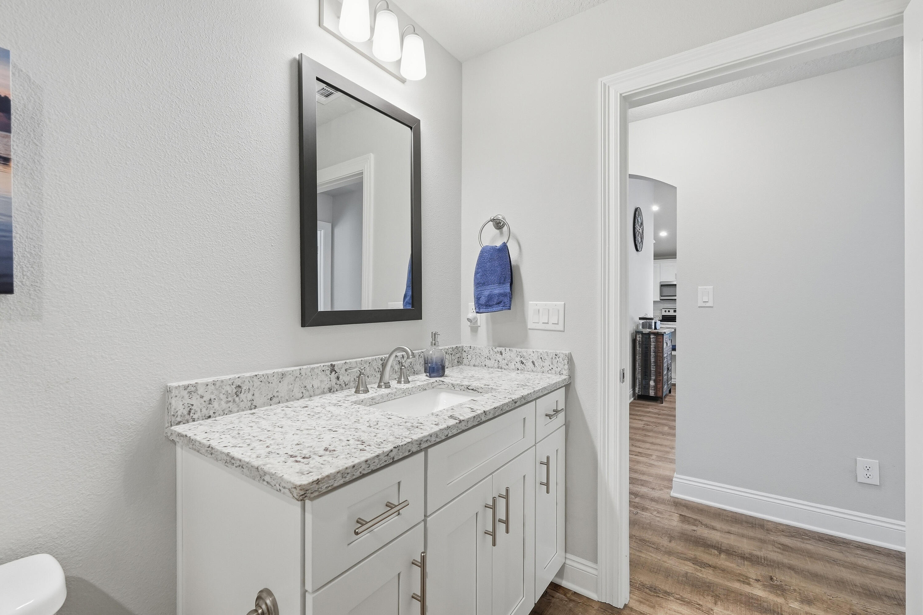 7434 Gordon Evans Road Navarre, FL 32566 - Photo 36 of 51 a bathroom with a granite countertop sink and a mirror
