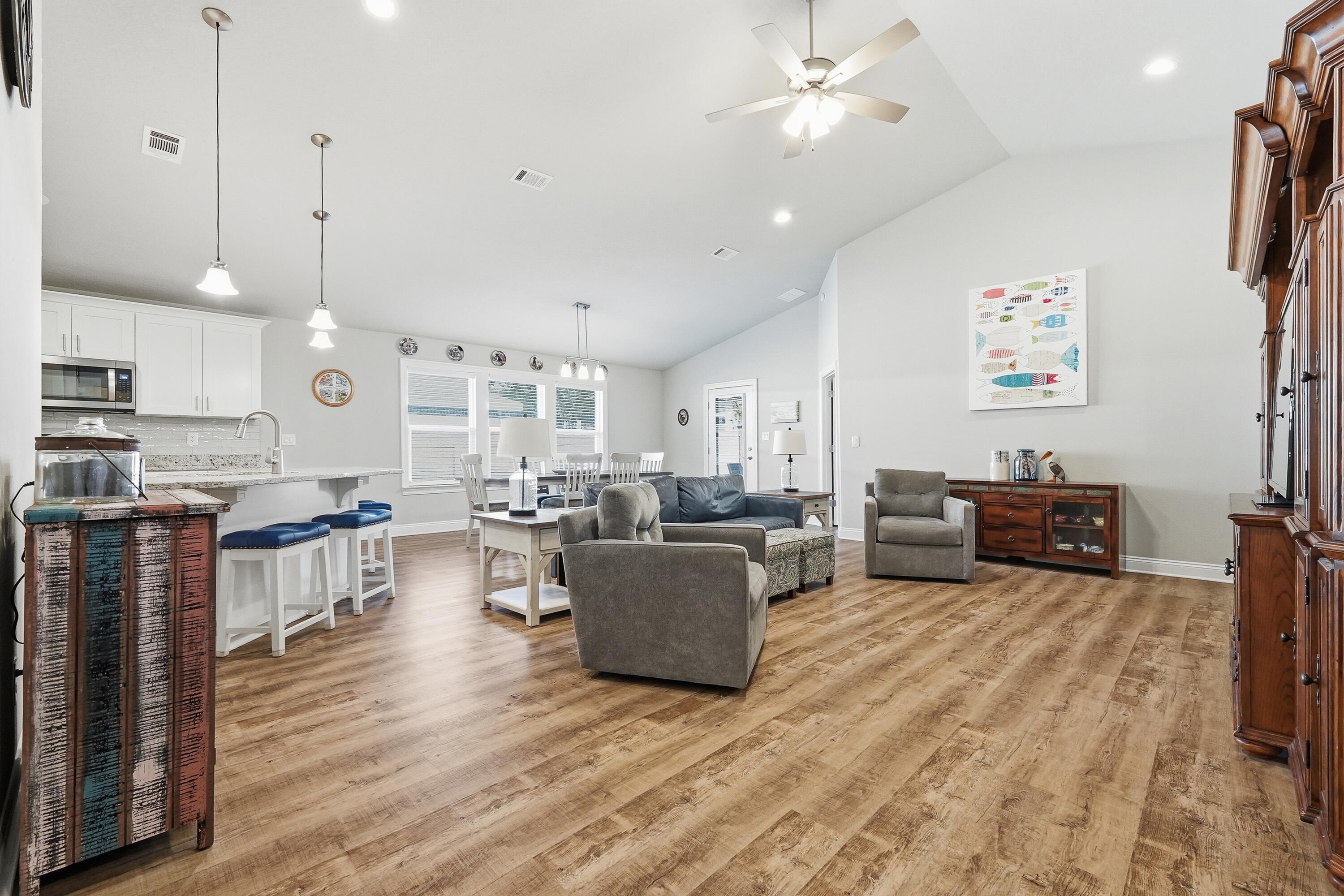 7434 Gordon Evans Road Navarre, FL 32566 - Photo 4 of 51 a living room with furniture and a wooden floor