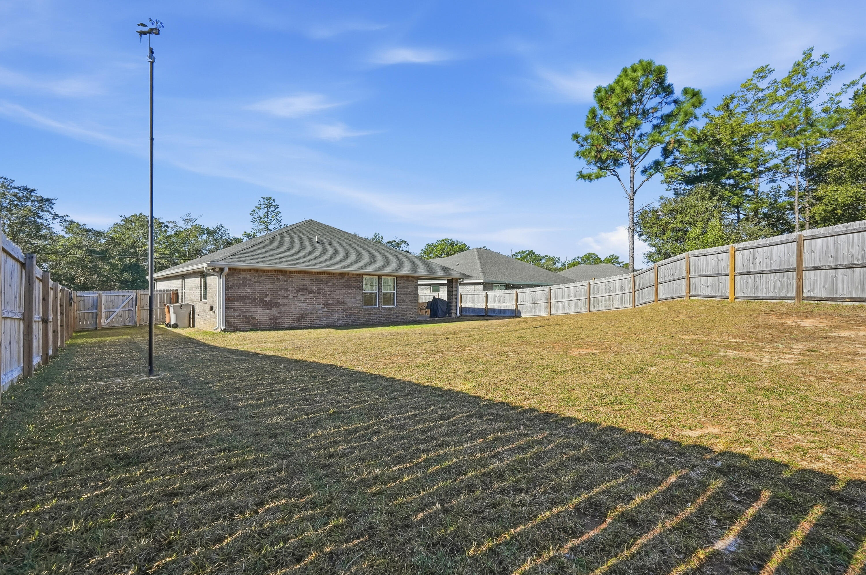 7434 Gordon Evans Road Navarre, FL 32566 - Photo 46 of 51 a bathroom with a tub and trees in the background