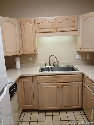 a kitchen with a stove and white cabinets