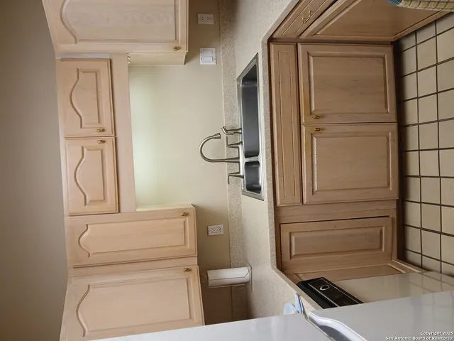 a bathroom with a granite countertop sink and shower