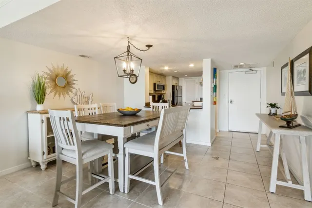 a kitchen with stainless steel appliances kitchen island granite countertop a refrigerator and a stove top oven with wooden floor