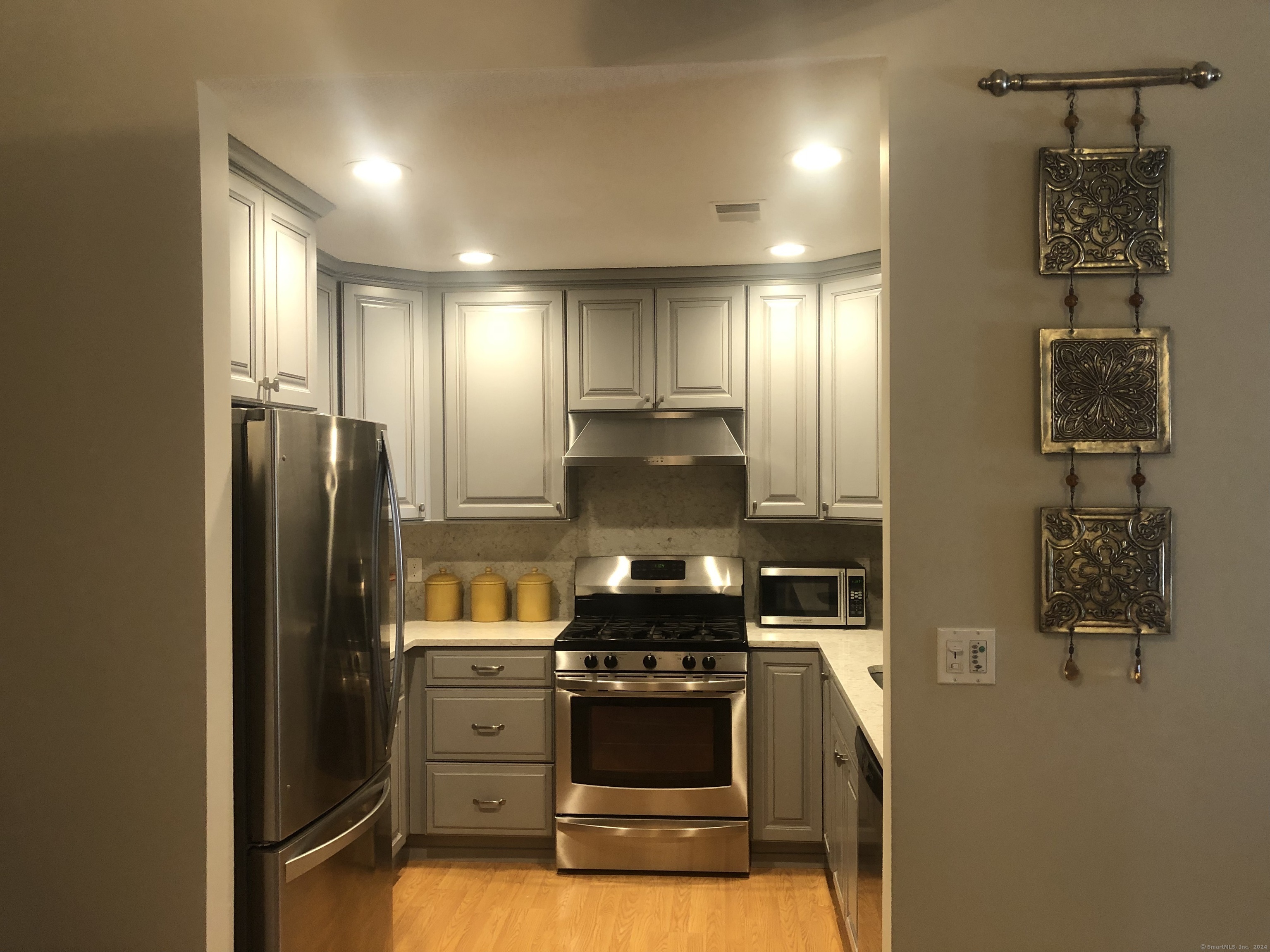a kitchen with a refrigerator and a stove