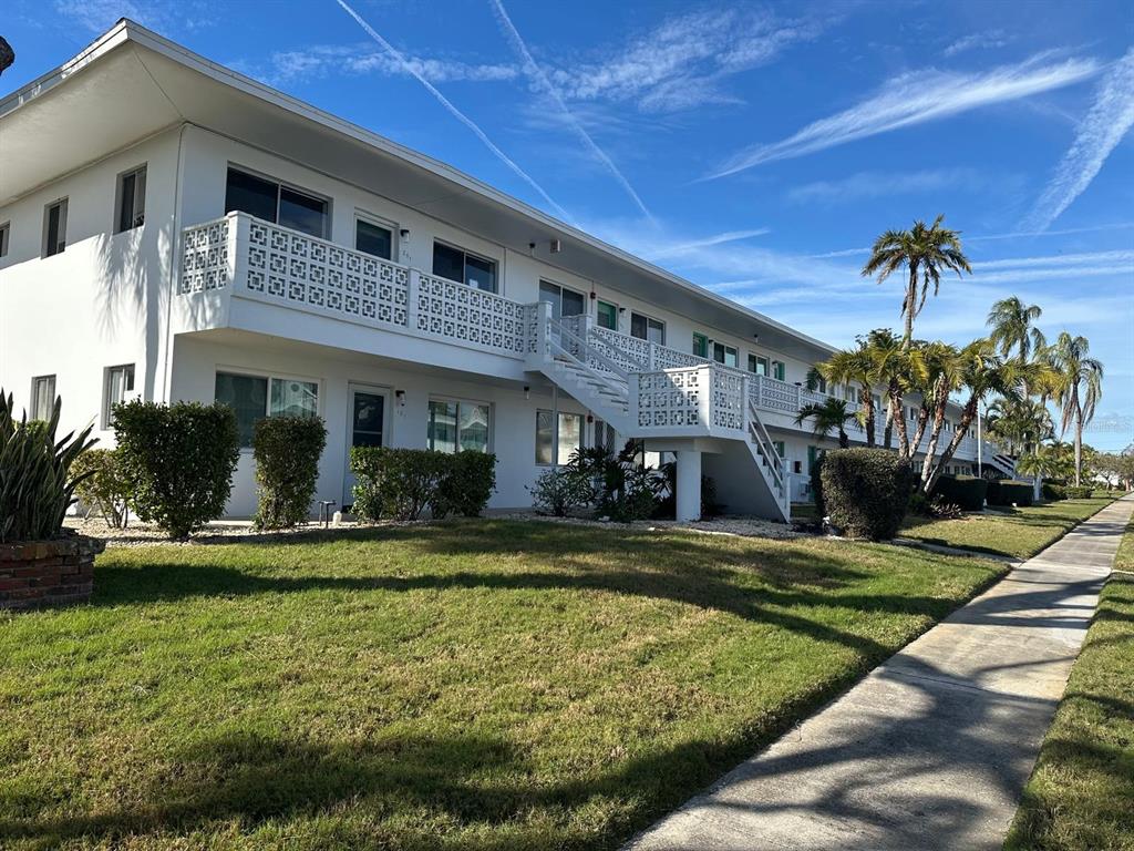 8450 112th Street North, Unit 102 Seminole, FL 33772 - Photo 1 of 80 a view of a house with swimming pool and a yard