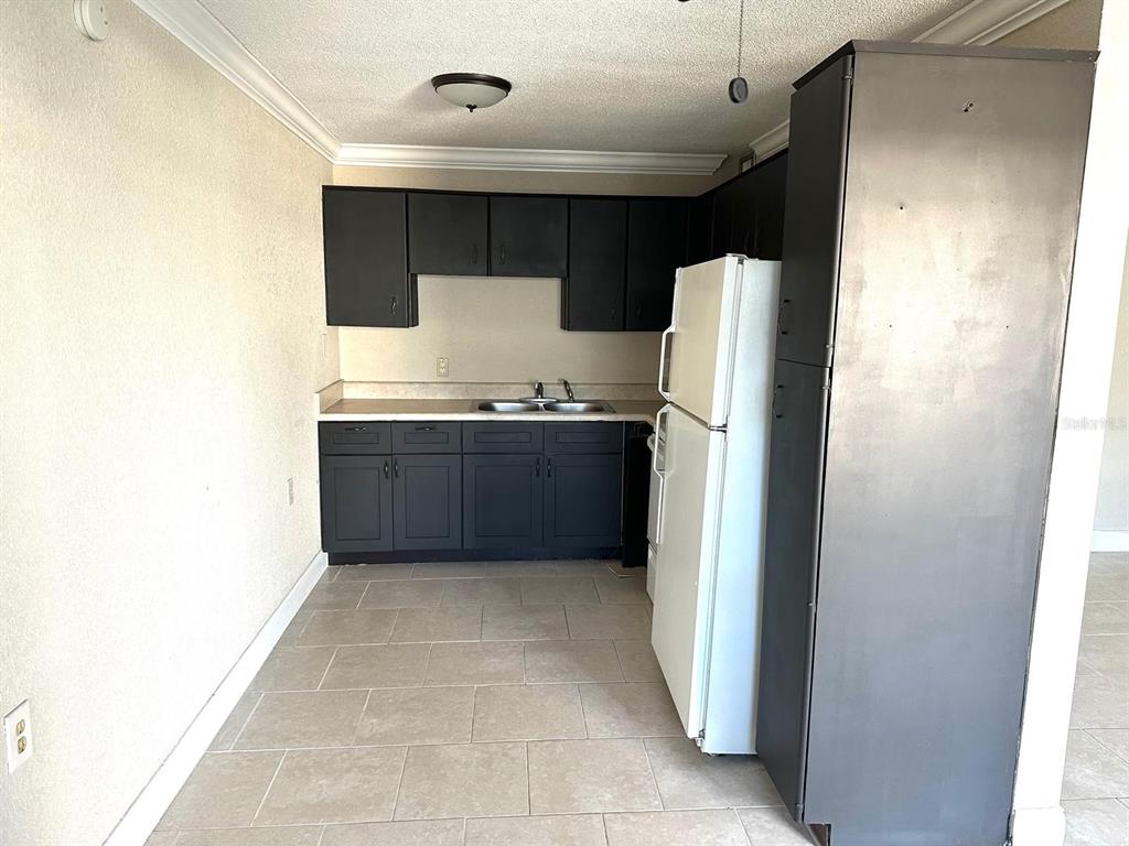 8450 112th Street North, Unit 102 Seminole, FL 33772 - Photo 14 of 80 a kitchen with stainless steel appliances a refrigerator and a stove