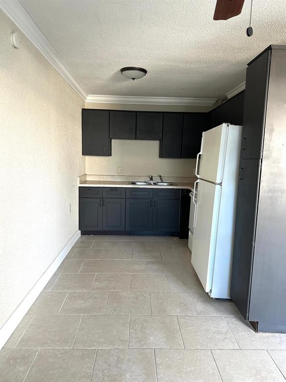 8450 112th Street North, Unit 102 Seminole, FL 33772 - Photo 16 of 80 a kitchen with refrigerator and white cabinets