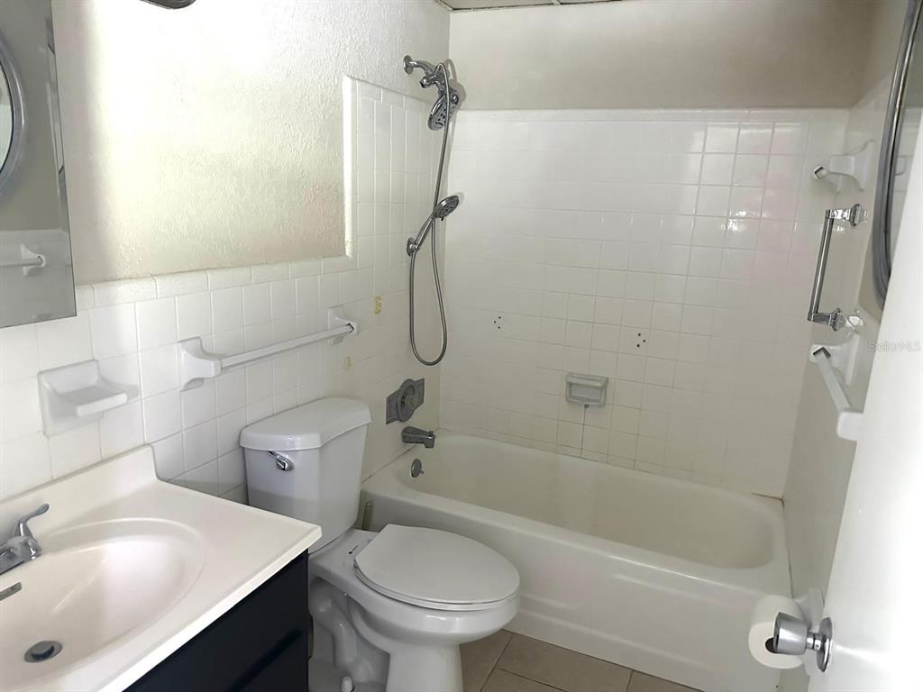 8450 112th Street North, Unit 102 Seminole, FL 33772 - Photo 23 of 80 a bathroom with a sink toilet and shower