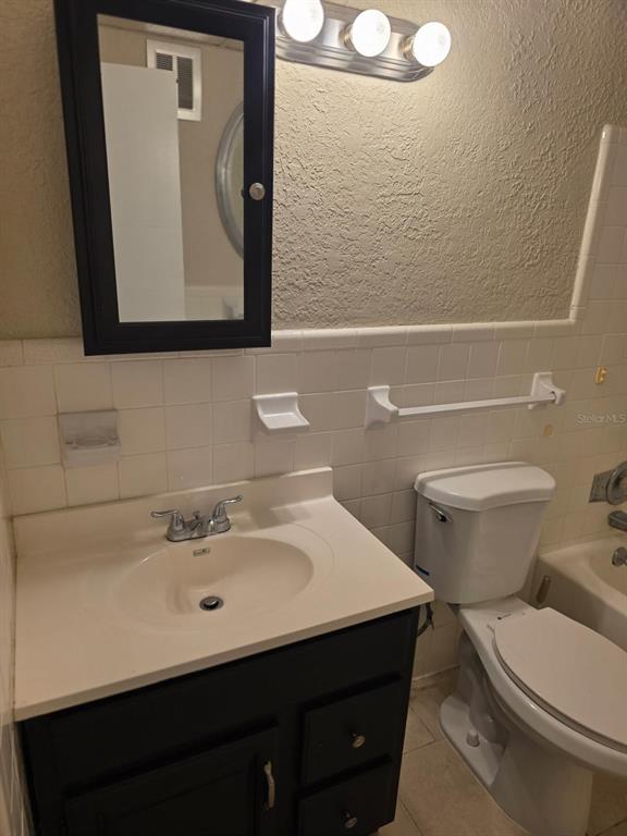 8450 112th Street North, Unit 102 Seminole, FL 33772 - Photo 24 of 80 a bathroom with a sink mirror and toilet