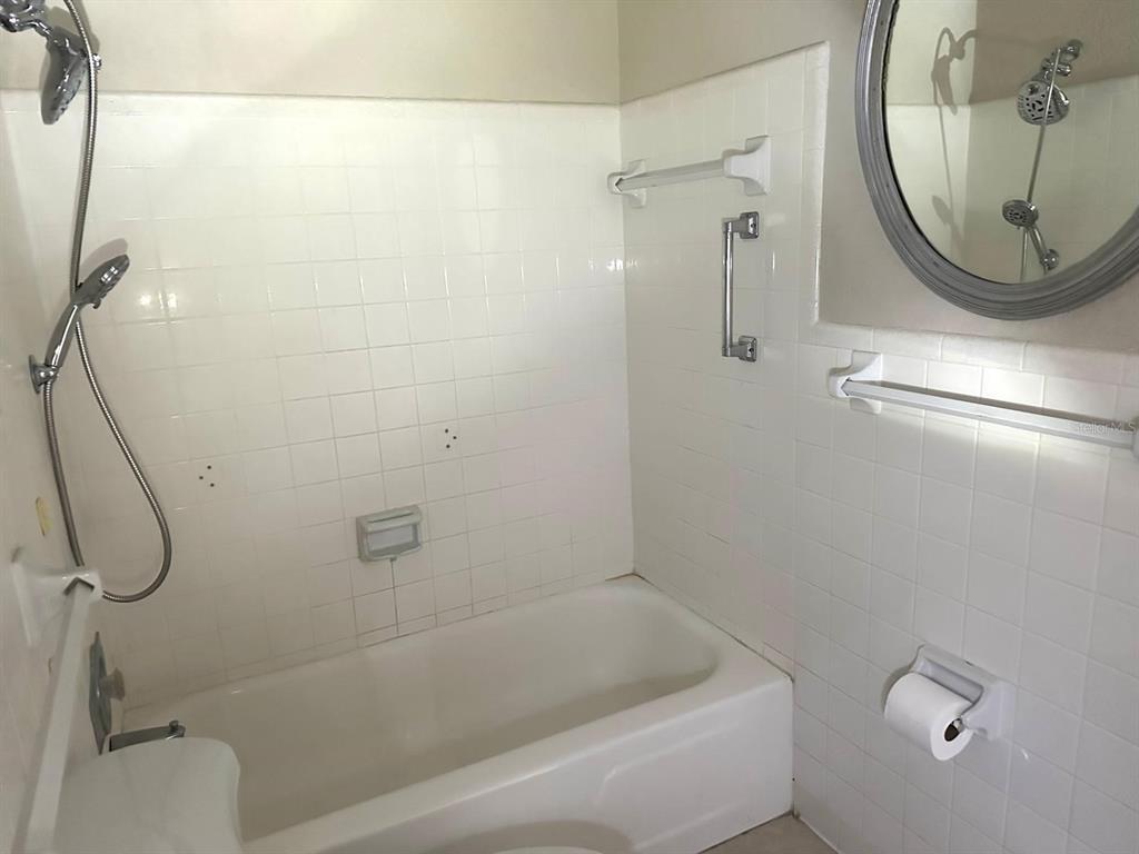 8450 112th Street North, Unit 102 Seminole, FL 33772 - Photo 25 of 80 a bathroom with a bath tub and a shower