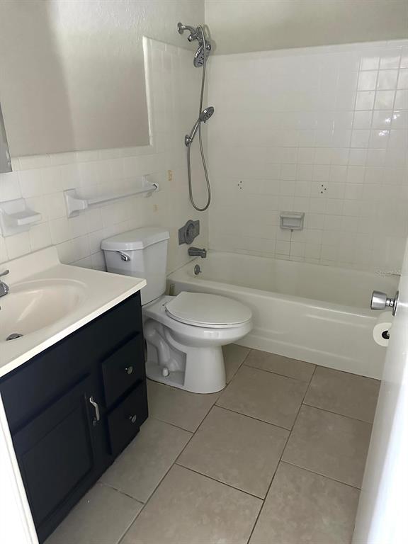8450 112th Street North, Unit 102 Seminole, FL 33772 - Photo 28 of 80 a bathroom with a granite countertop sink a toilet and a bathtub