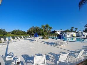 8450 112th Street North, Unit 102 Seminole, FL 33772 - Photo 54 of 80 a view of a swimming pool with outdoor seating