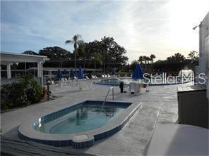8450 112th Street North, Unit 102 Seminole, FL 33772 - Photo 57 of 80 a view of a swimming pool with outdoor seating