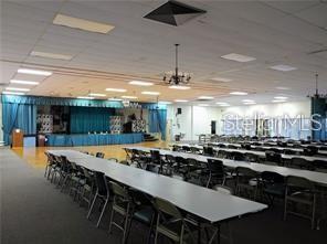 8450 112th Street North, Unit 102 Seminole, FL 33772 - Photo 63 of 80 a dining table with chairs and chandelier