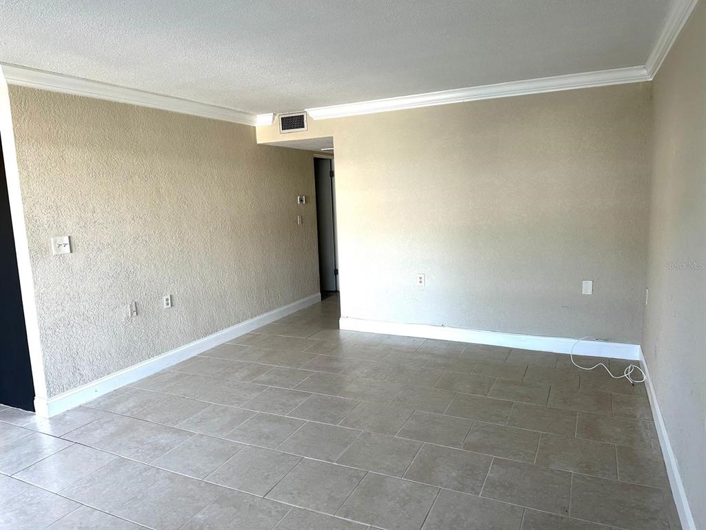8450 112th Street North, Unit 102 Seminole, FL 33772 - Photo 7 of 80 a view of an empty room with wooden floor