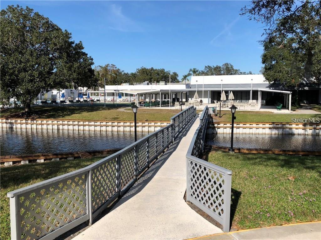 8450 112th Street North, Unit 102 Seminole, FL 33772 - Photo 75 of 80 a view of a house with backyard and lake view