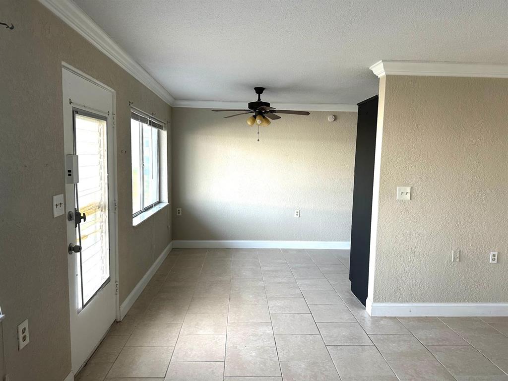 8450 112th Street North, Unit 102 Seminole, FL 33772 - Photo 8 of 80 an empty room with windows and a ceiling fan