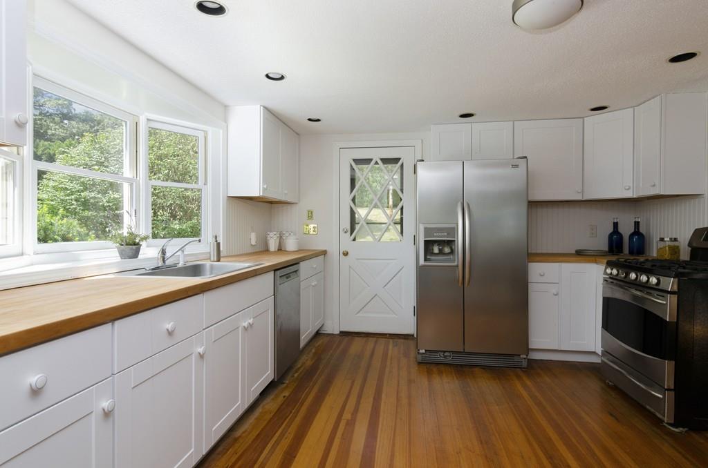 34 Stowe Road Sandwich, MA 02563 - Photo 6 of 19 a kitchen with stainless steel appliances granite countertop a refrigerator a sink dishwasher a stove and white countertops with wooden floor