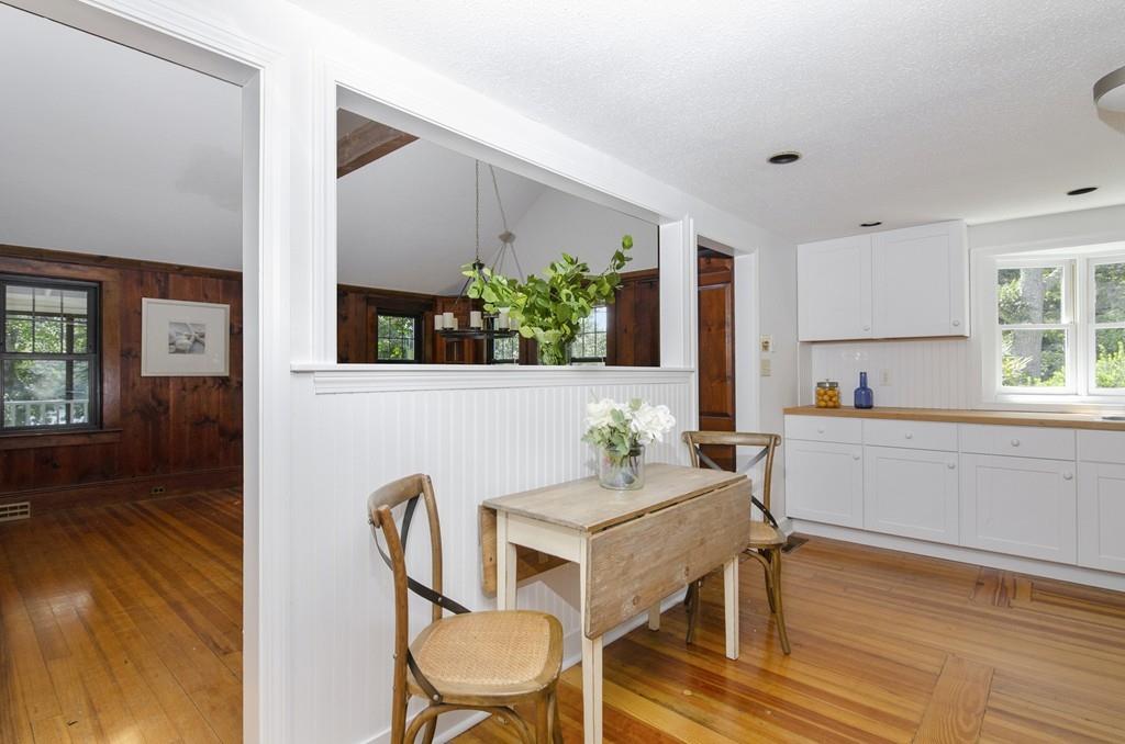 34 Stowe Road Sandwich, MA 02563 - Photo 7 of 19 a kitchen with granite countertop a table chairs stove and wooden floor