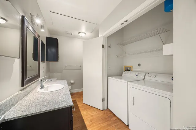 a bathroom with a granite countertop sink a toilet and shower