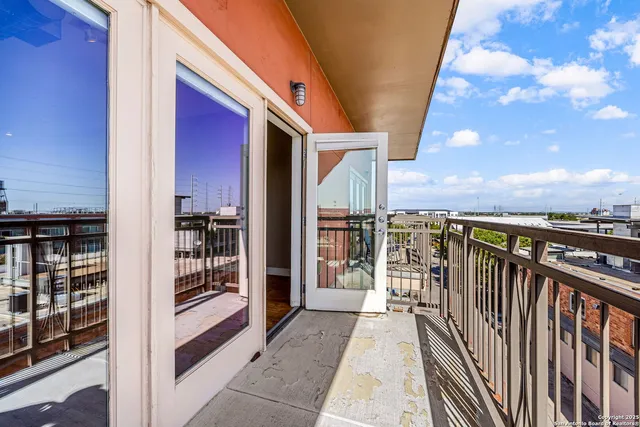 an aerial view of a city with lots of residential buildings ocean and mountain view in back