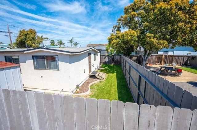 a view of a house with wooden fence
