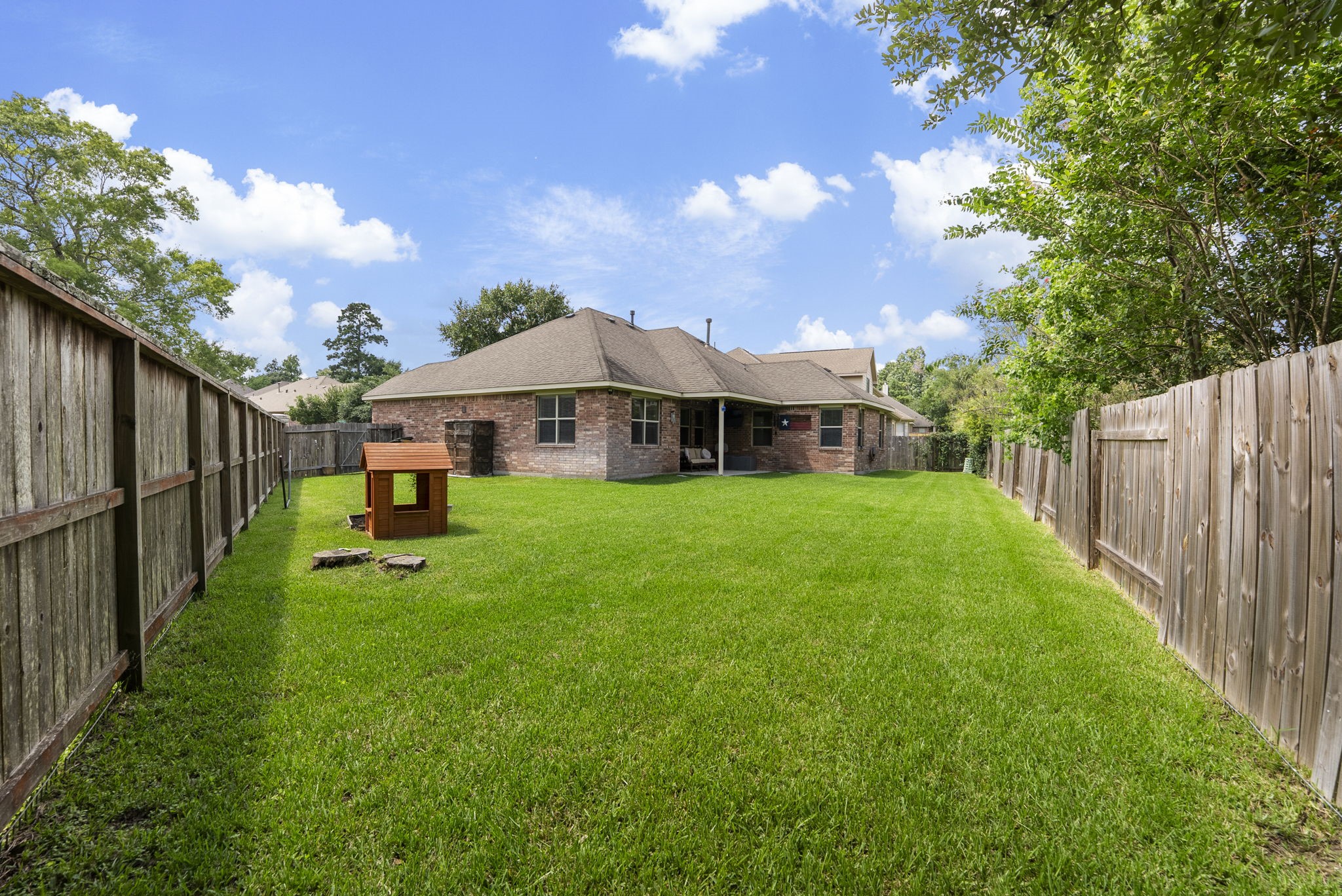 174 Maple Grove Drive Conroe, TX 77384 - Photo 22 of 26 Situated on a pie-shaped lot, this home delivers an impressive amount of backyard space that's hard to find.